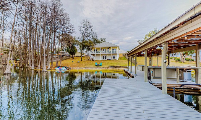 Marianna Maison | Lakefront home with amazing sunset/water view, private dock, & firepit