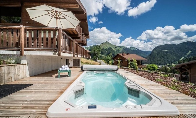 La Cote-d'Arbroz Chalet De Ski | Lovely wooden balconies, a swing chair with the most picturesque view