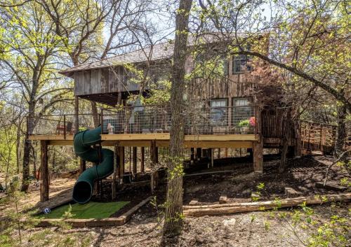 Dennis Maison | Magical Treehouse with Slide by Brazos River for Family Glamping Adventures in Texas