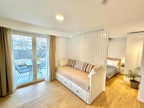 Olymbiaki Akti Maison | Minimalist Seaside Apartment with Private Patio and Parking - Blue Zone Homes