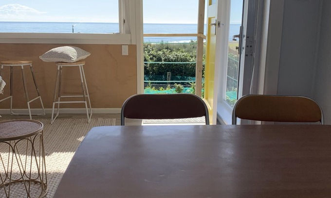 Cape Palliser Maison | Ocean views of the Kaikoura's and surf break. Private beach hut.
