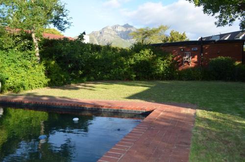 Die Boord Maison | Retro Red Stone Villa with pool & lush garden