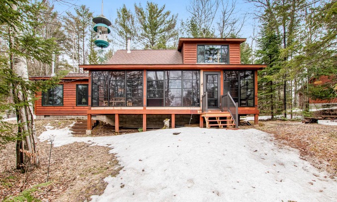 Lac du Flambeau Cabine | Riverfront vacation home with a dock, wood stove, full kitchen, & firepit