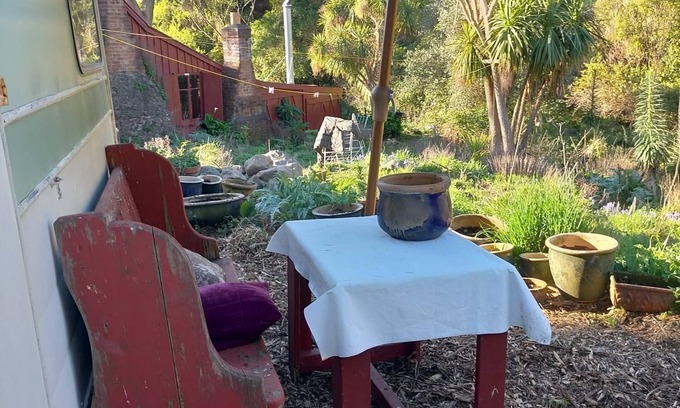 Akaroa Maison | Stylish vintage caravan on a farm over looking bush and river.