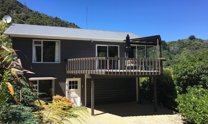 Te Mahia Maison | Bach ensoleillé au-dessus d'une plage de baignade isolée