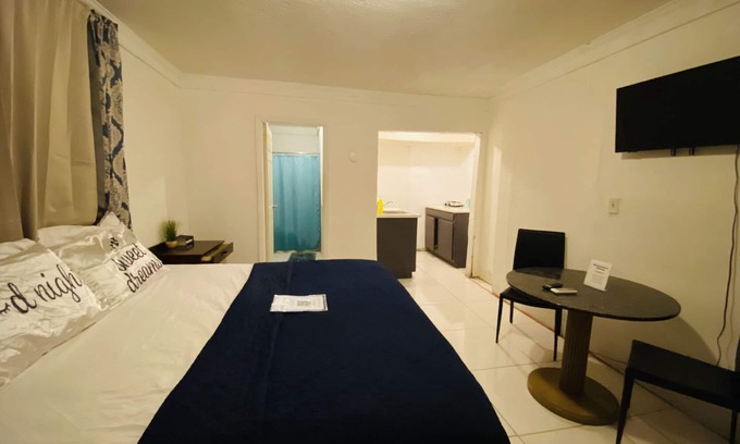 Nassau Maison | The Dollie Mae: Comfortable King Bed Suite