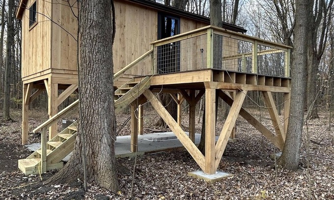 Girard Cabine | Timber framed tree cabin nestled in the woods.