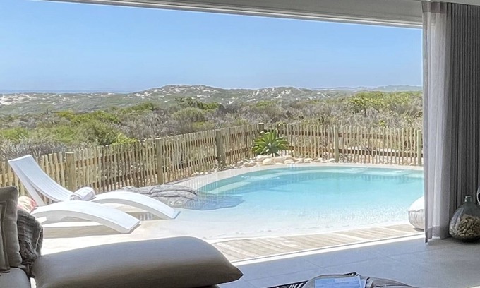 Grotto Bay Maison | Tranquil haven: home in nature's embrace, where ocean and dunes unite.