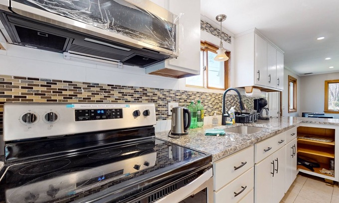 Sandown Maison | Two-story dog-friendly home with a lake view, deck, gas grill
