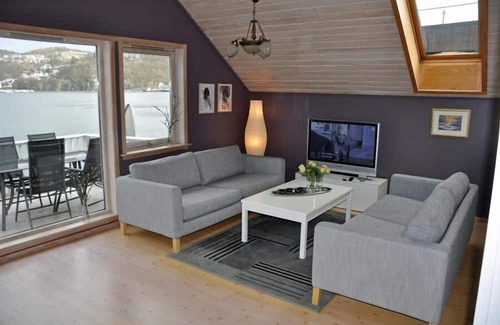 Flekkefjord Appartement | Holiday apartment "Fagerstrand 1", in Flekkefjord, southern Norway, in a beautiful location directly on the water, 4-6 persons, open living-dining area, 2 bedrooms, 1 loft with double mattress, 1 bathroom, Internet, own small veranda with access t...