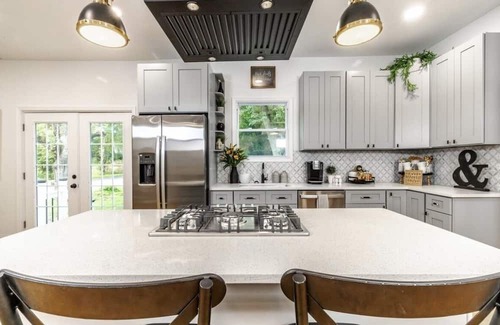 Mickleton Maison | Embrace the charm of our creekside haven featuring 4BR 3BA yoga and BBQ deck.