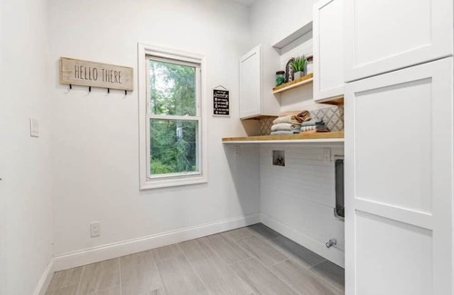 Mickleton Maison | Embrace the charm of our creekside haven featuring 4BR 3BA yoga and BBQ deck.