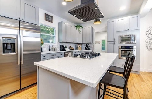 Mickleton Maison | Embrace the charm of our creekside haven featuring 4BR 3BA yoga and BBQ deck.