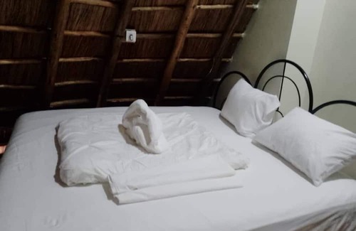 Western Region Autre | White Cat Farm Hut Inn is nestled on the outskirts of a quaint African village