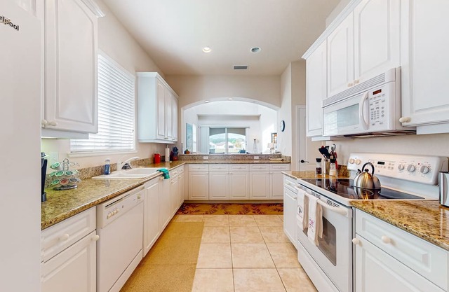 Corner-lot home with water view, on-site golf, enclosed patio, BBQ, & W/D