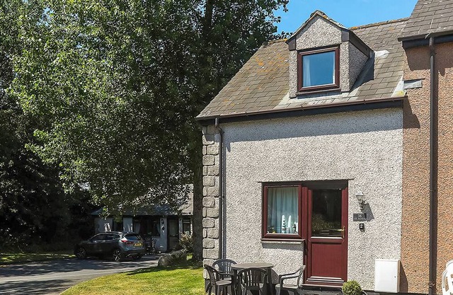 This silver cottage features an open kitchen, dining room, and living room.
