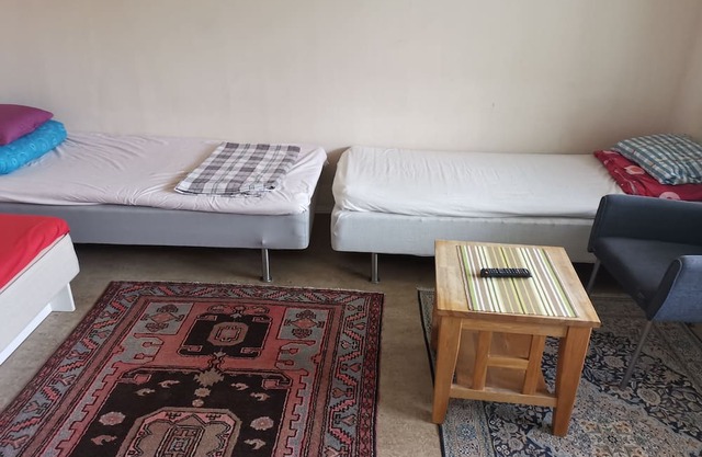 One large room with 3 single beds. Max for three people 12 min from city center
