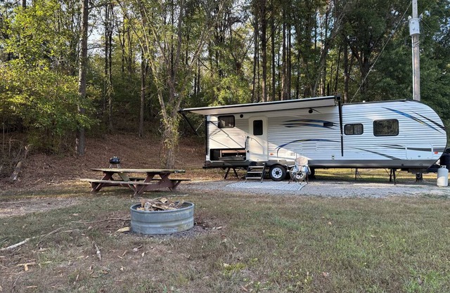 Camper in country setting beside water, near Burning Star Wildlife area