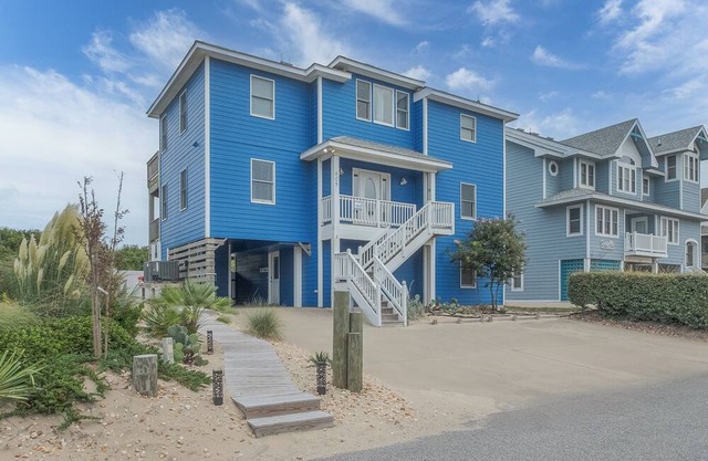 Experience luxury at 1861 - Into the Mystic, a spacious 6-bedroom oceanfront home in Corolla, NC.