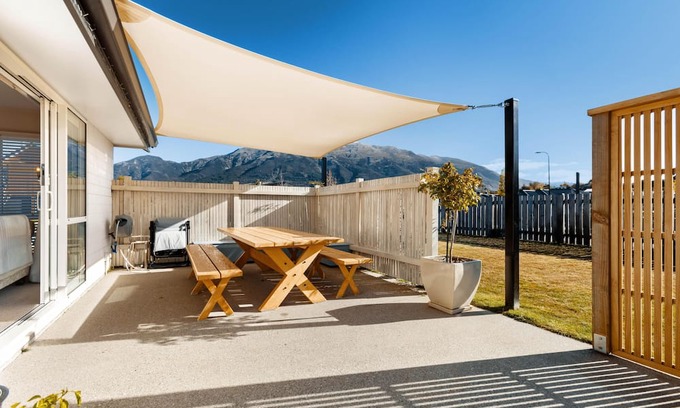 Lake Hawea Maison | Home nestled in Hawea - A four-bedroom Hawea home with mountain views. Enjoy a modern kitchen, spacious living areas, two bathrooms, and a cosy fireplace